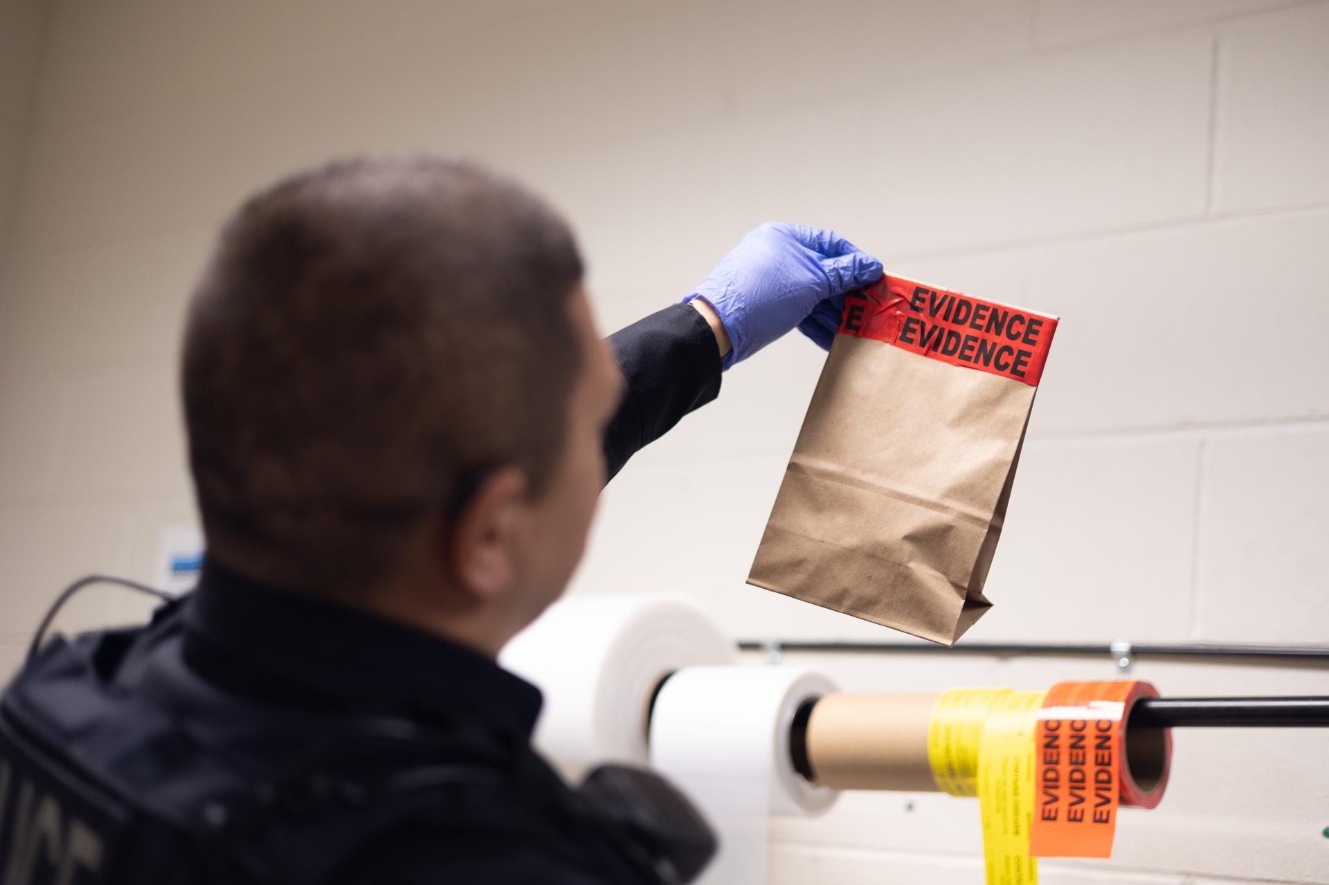 Martinez holding up Faux Evidence Bag