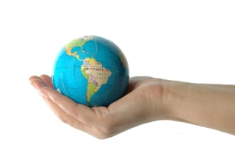 Holding a mini globe.